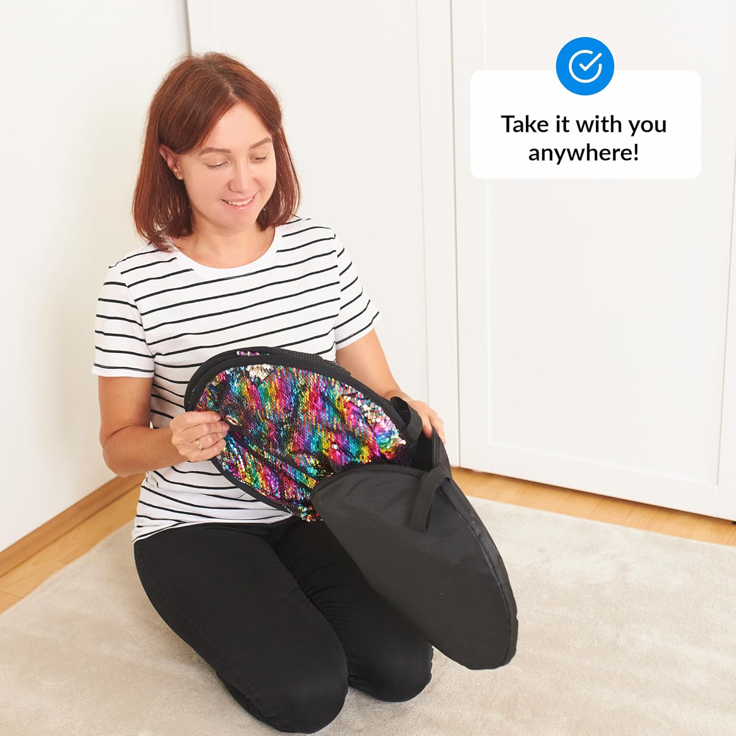 Woman holding a colorful sequin mat with text 'Take it with you anywhere!' on a white background